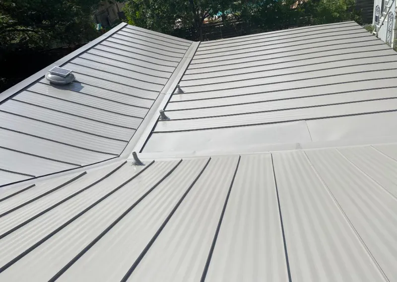 Solar attic fan installed on a metal roof for Roof Ventilation in Akron